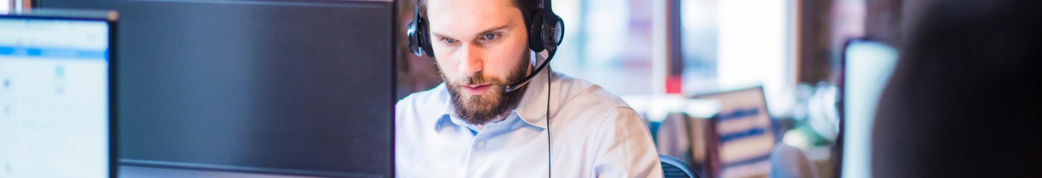 selective-focus-photo-of-man-in-official-shirt-sitting-in-2451645